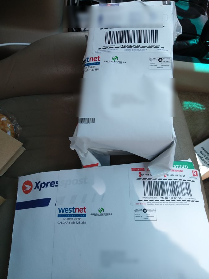Xpresspost parcels under WestNet-branded labels — addresses obscured